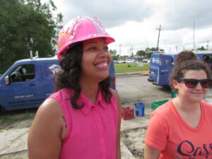 Person smiling in pink hardhat.