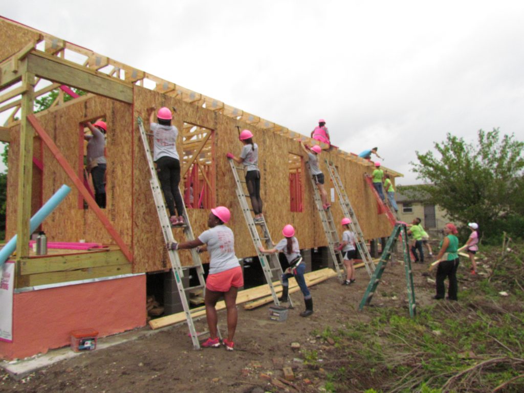 Volunteers working on the exterior of a Habitat home at Women Build 2019.