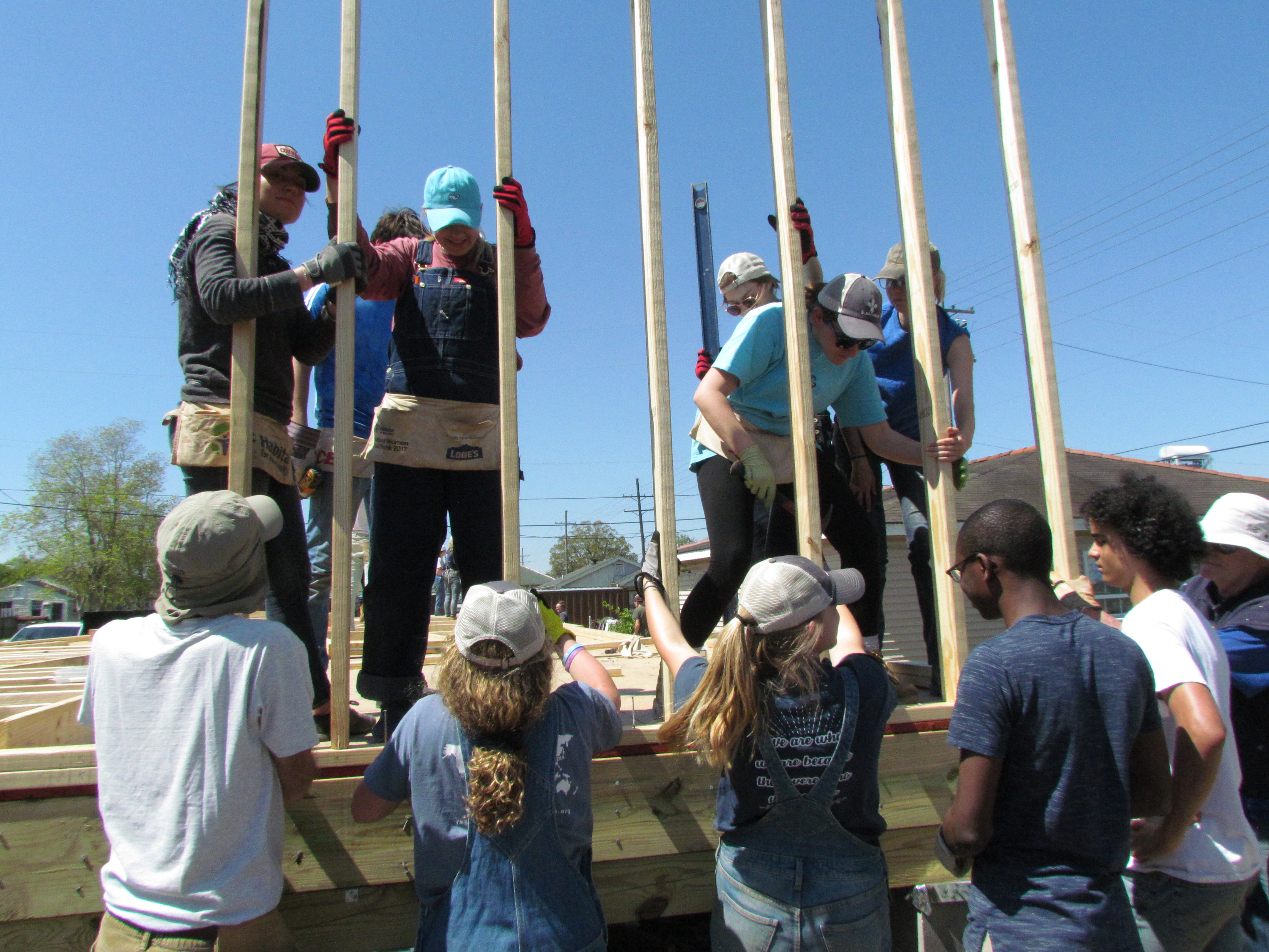 Volunteers raise the walls on a Habitat home.