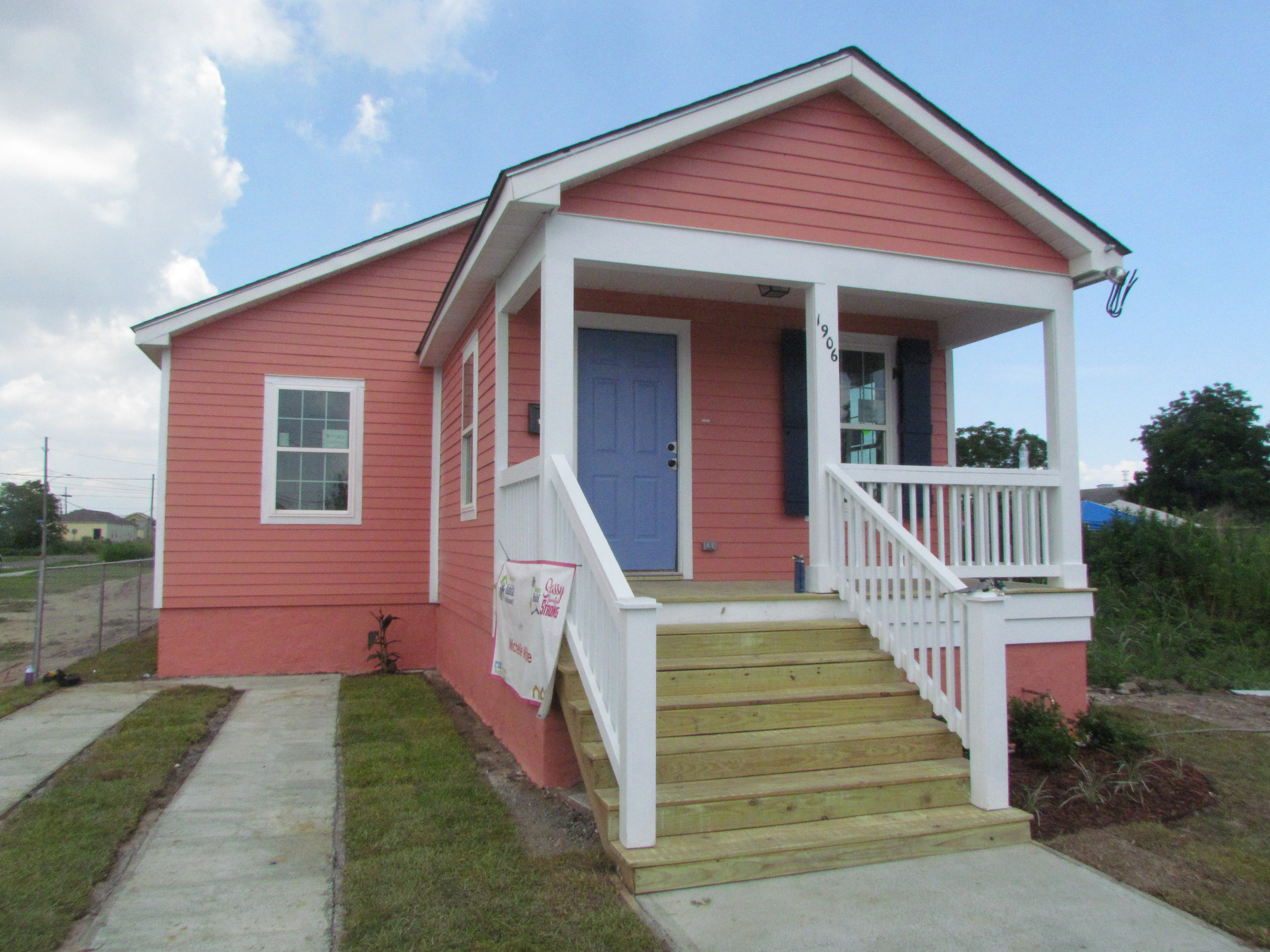Pink Habitat house with short porch.