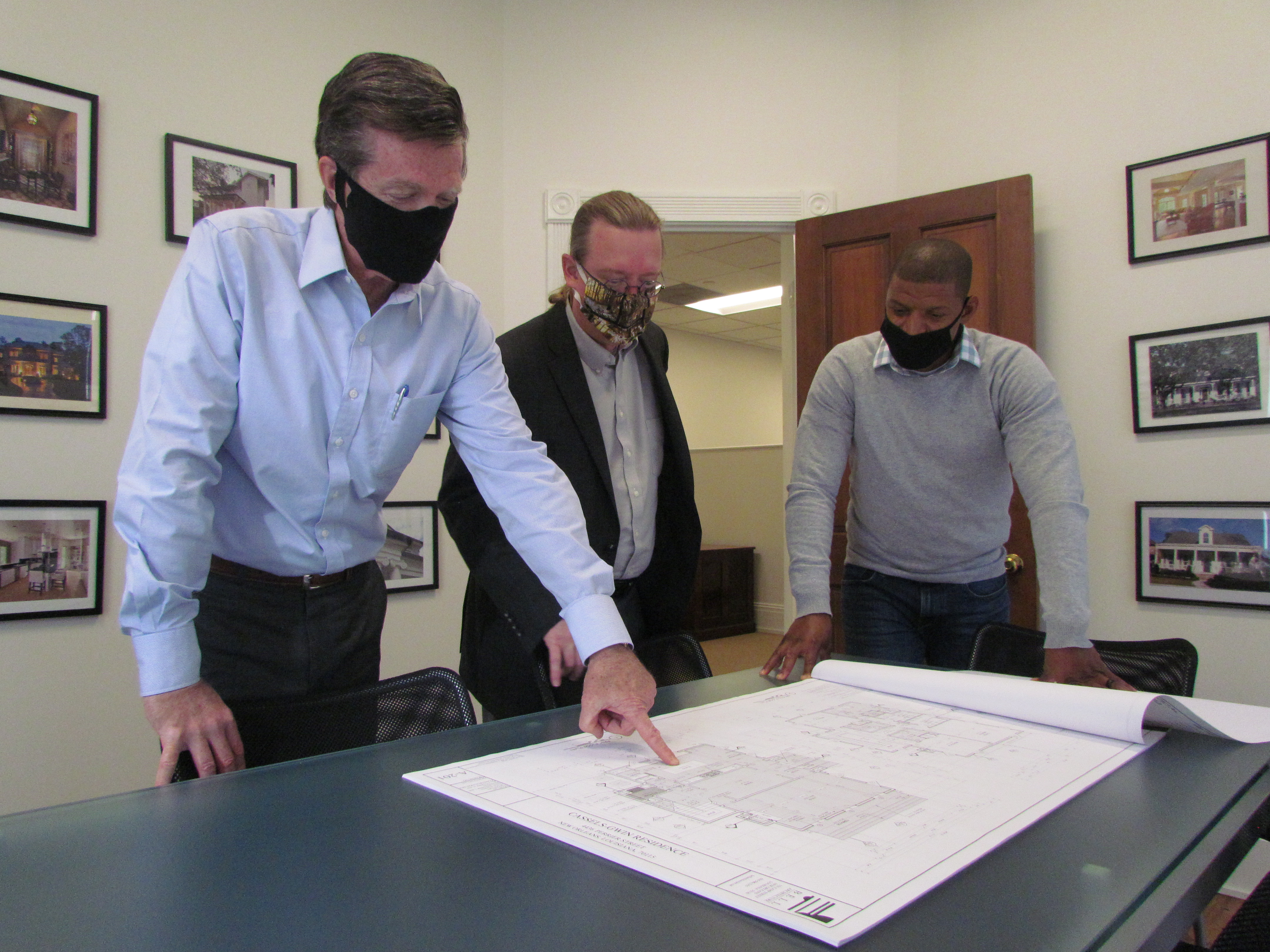 Architects and engineer look over floor plans.